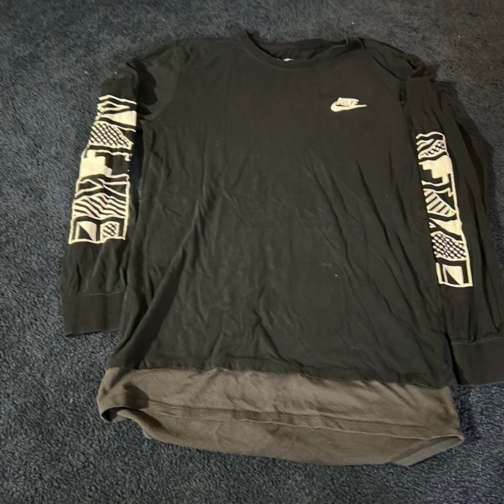 Nike long sleeve T-shirt with swish on left chest and Nike going down both arms